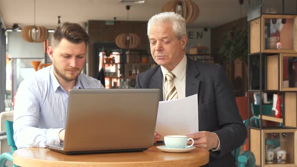 Partners Have Business Meeting at the Cafe