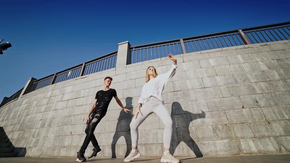 Couple dancing outdoor. Cheerful young couple dancing outdoors and having fun