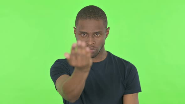 Angry African Man Inviting for Fight on Green Background