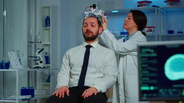 Woman Researcher Putting Brainwave Scanning Headset