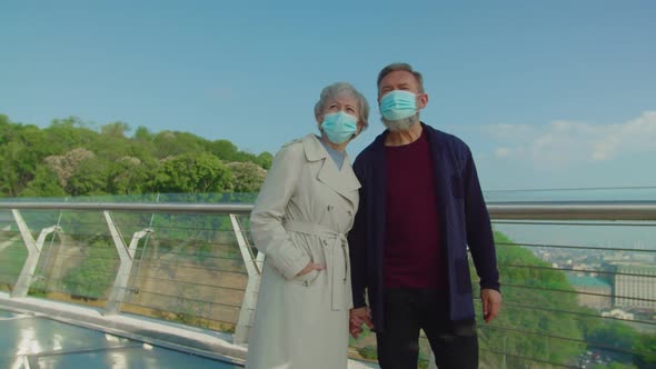 Aged Responsible Tourists Wearing Medical Masks in Public Place