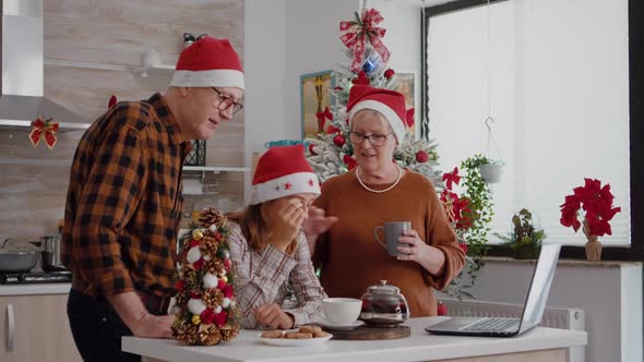 Family Talking with Remote Parents During Online Videocall Meeting on Laptop