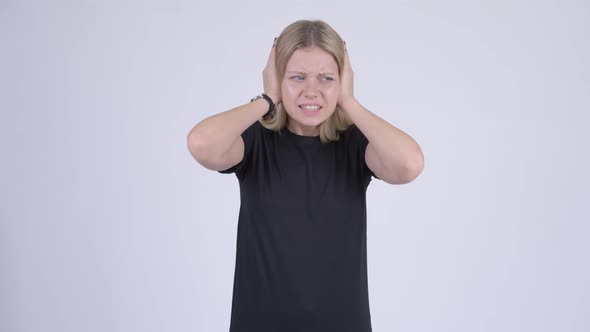 Young Stressed Blonde Woman Covering Ears From Loud Noise