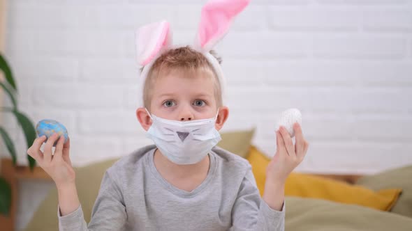 Boy in Rabbit Bunny Ears on Head and Protective Mask Having Fun Looking Into the Camera Making Crazy