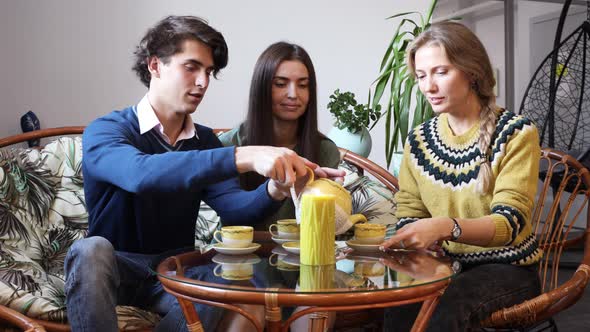 Group of Young People Talking in a Cafe