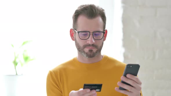 Portrait of Man Making Online Payment on Smartphone
