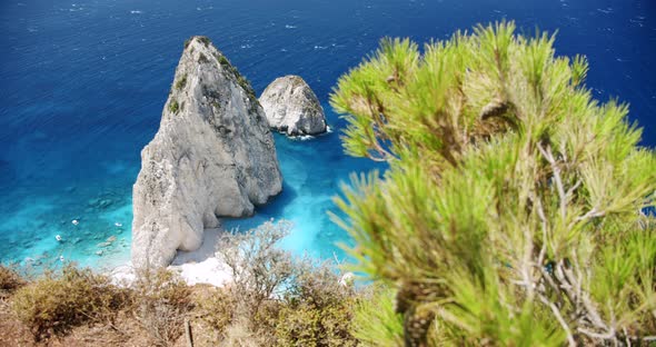 Remote Beach with Huge White Rock Formation with Blue Lagoon Tourist Pleasure Boats