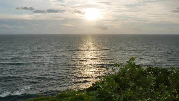 Scenic Sunset Over Indian Ocean and Green Plants on the Foreground Bali   Wide Shot