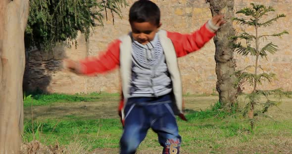 one Asian, Pakistani kid dances in the park