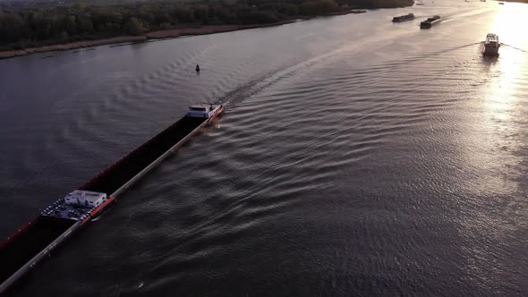 Cargo Ship Of Explosief Sails Down The River In Barendrecht Town In Netherlands. aerial