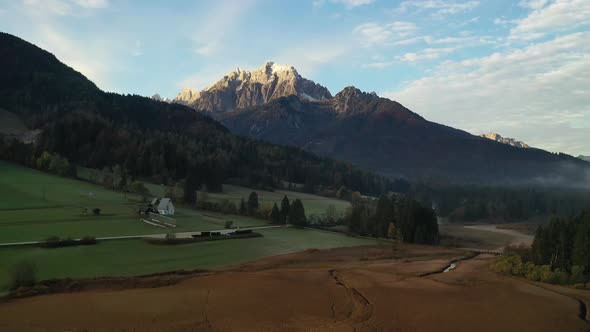 Flying over autumn landscape at sunrise