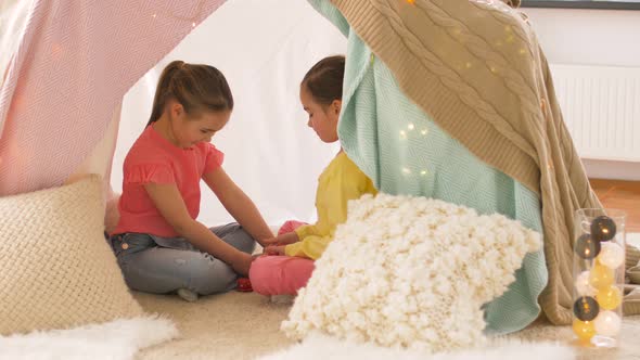 Happy Girls in Kids Tent Playing Tea Party at Home