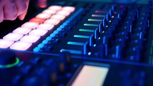 Professional DJ Plays Beat Sampler with Color Drum Pads and Samples in Studio