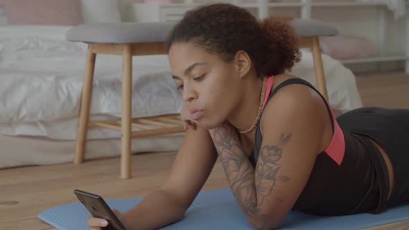 Pretty Black Woman Browsing Content on Cellphone