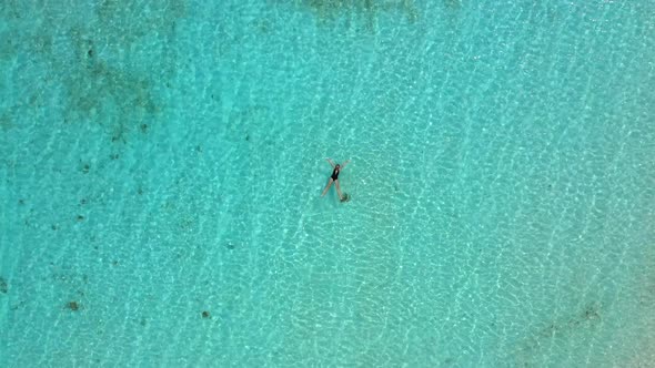 Young Woman in Bikini Is Swimming in the Transparent, Azure Sea. Aerial View of Slim Woman Floating