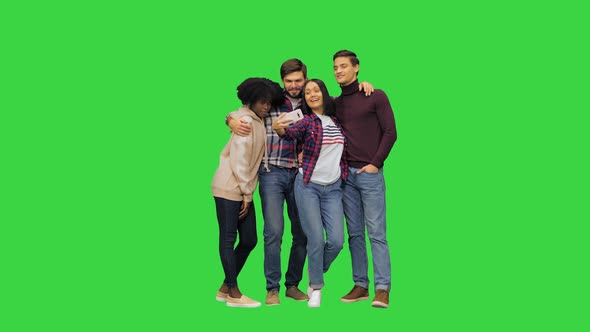 Four Friends Two Girls and Two Boys Taking a Selfie Posing Smiling Looking at the Camera on a Green