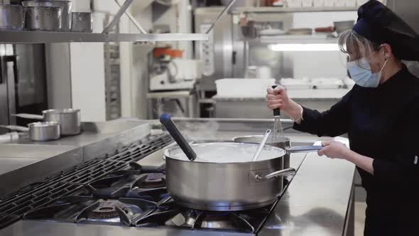 Portrait of Confident Female Chef Working in Commercial Kitchen