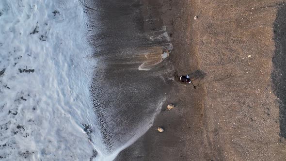 A Man Searches for Gold After a Storm Aerial View 4 K Turkey Alanya