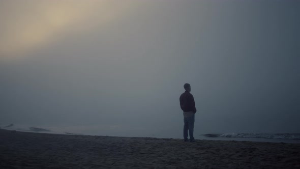 Calm Man Standing on Beach at Sea