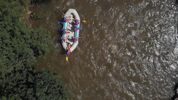 Aerial View Group of Friends Rafting on Mountain River