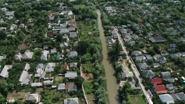 Aerial View of the River Flowing Through the Village on a Summer Day