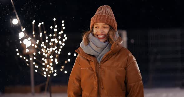 Portrait of Young Woman on the Backyard of Her House on Winter Holidays