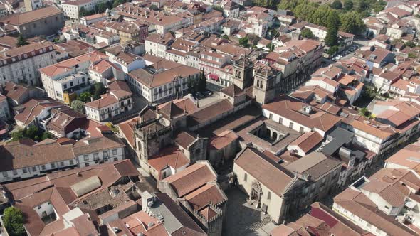 Aerial circular view of historic center of Braga. Some ancient squares and churches are visible.