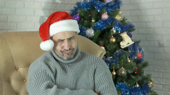 Man in Hat at Sad New Year Party at Home