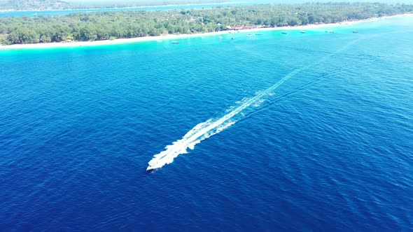 Aerial flying over scenery of beautiful coast beach break by blue lagoon and white sandy background 