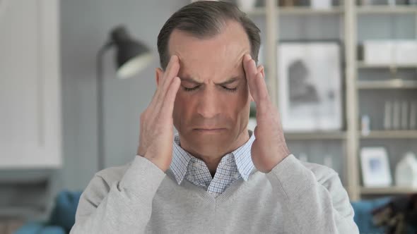 Headache Portrait of Tense Middle Aged Man in Office