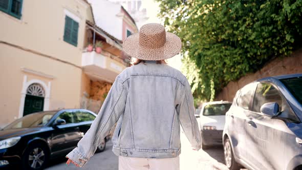 Back View of Traveler Woman in Hat Walking in Old Italian City