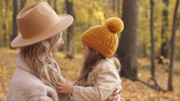 Blonde Adult Woman with Daughter in Autumn Forest