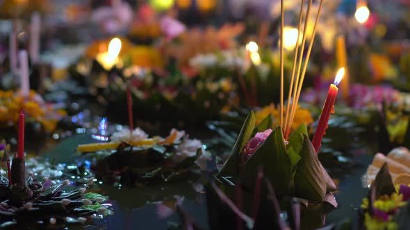 Lots of Krathongs Floating on the Water. Celebrating a Traditional Thai Holiday - Loy Krathong