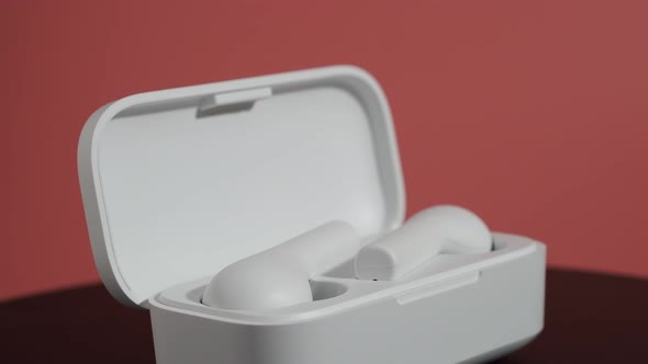 White Wireless Headphones on a Pink Background