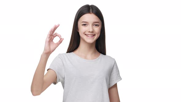 Portrait of Cheerful Student Girl Looking at Camera with Smile and Gesturing on Camera with Ok Sign