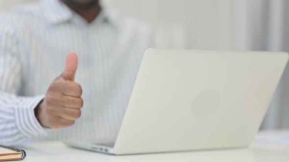 Close Up of African Man Using Laptop Showing Thumbs Up