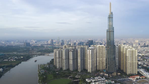 Drone Hyperlapse of Central Park, Landmark, Saigon river and city skyline early in the morning