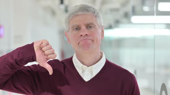 Unhappy Middle Aged Man Showing Thumbs Down