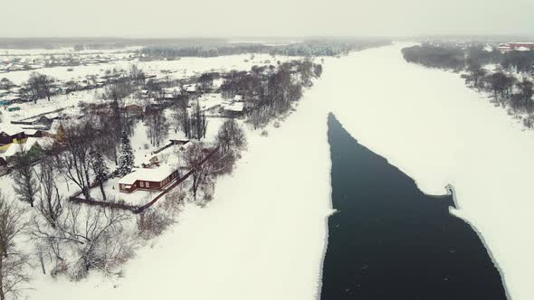 Dramatic Winter Landscape Aerial View Frozen River and Town on the Shore