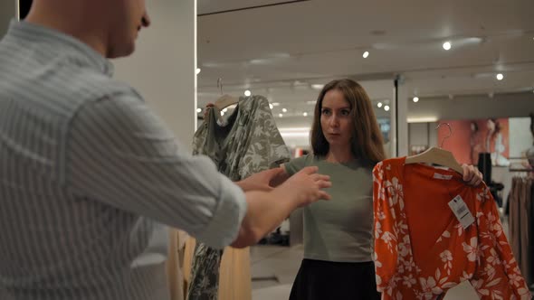 The Girl in the Store Asks the Guy's Advice Choosing Between Two Dresses