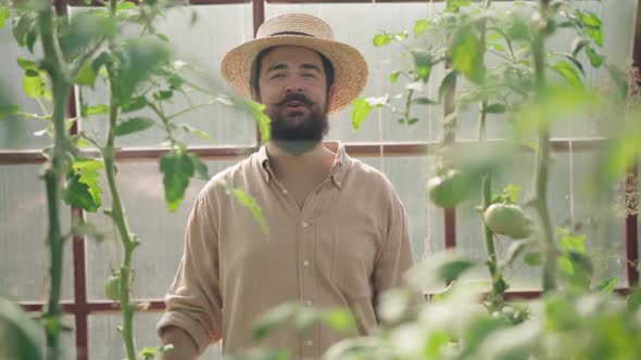 Portrait of Confident Handsome Caucasian Male Gardener Talking Looking at Camera Standing in