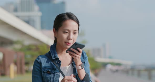 Woman Talk to Smart Phone in City