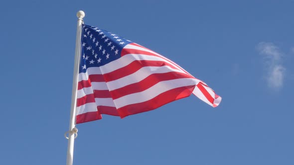 Flowing on the wind fabric of American flag against blue sky 4K 2160p 30fps UltraHD video - Famous f