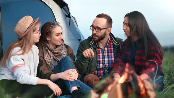 Cheerful Guy and Girls Communicating at Hiking Camp Having Positive Emotion