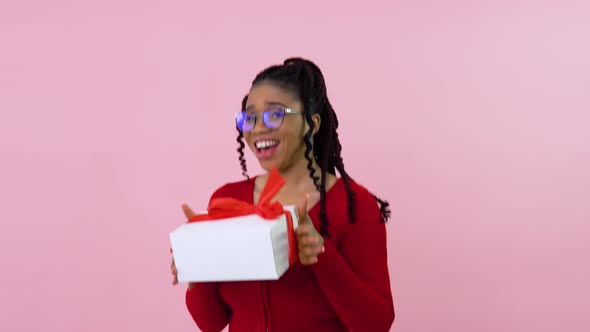 Cute Young African American Girl Dancing with a Gift