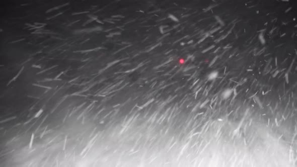 A Car Driving Down the Highway Through Snow and Blizzard Looking Through the Windshield POV