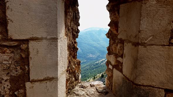 Incredible nature of Gran Sasso mountains seen through fortress loophole. Italy