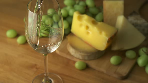 Pouring white wine into glass, Slow Motion