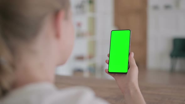Rear View of Woman Looking at Smartphone with Green Chroma Screen