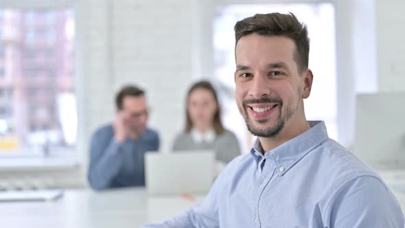 Young Creative Professional Smiling at the Camera in Office